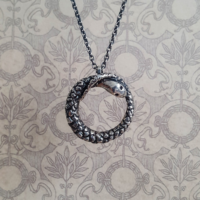 Ouroboros snake necklace, close up of pendant and chain.