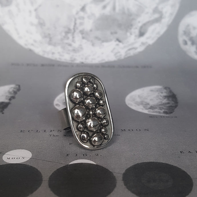 Rustic statement silver ring with balls on an oval shape.