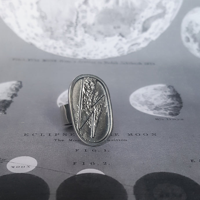 Statement silver ring with a Ziggy Stardust lightning in an oval shape.