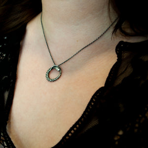 Ouroboros snake necklace, on a woman's neck.