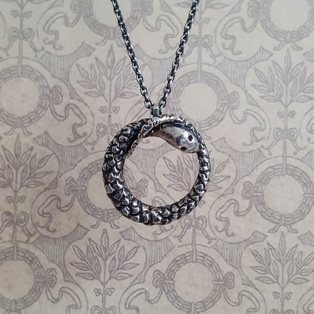 Ouroboros snake necklace, close up of pendant and chain.